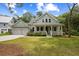 Charming two-story home featuring a welcoming front porch, complemented by a lush green lawn and manicured landscaping at 3226 Waverly Ln, Johns Island, SC 29455