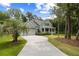 Inviting two-story home boasts a manicured lawn, mature trees, and a spacious driveway leading to an attached two-car garage at 3226 Waverly Ln, Johns Island, SC 29455
