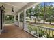 Relaxing front porch with wood floors, white columns, and serene views of the beautifully landscaped neighborhood at 3226 Waverly Ln, Johns Island, SC 29455