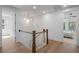 Bright hallway with hardwood floors, wainscoting, and a modern chandelier creates an inviting transition space at 3226 Waverly Ln, Johns Island, SC 29455