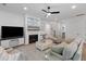 Bright living room features hardwood floors, a fireplace, comfortable seating, and seamless access to additional living spaces at 3226 Waverly Ln, Johns Island, SC 29455
