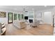 Inviting living room with hardwood floors, a fireplace, and large windows providing natural light and outdoor views at 3226 Waverly Ln, Johns Island, SC 29455