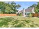 Large backyard featuring a manicured lawn, mature trees, and an outdoor patio area at 3257 Heathland Way, Mount Pleasant, SC 29466