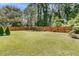 Cozy backyard patio featuring an outdoor table with seating and mature landscaping at 3257 Heathland Way, Mount Pleasant, SC 29466