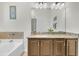 Bathroom features granite counters, a decorative mirror, vanity lighting, and a soaking tub at 3257 Heathland Way, Mount Pleasant, SC 29466