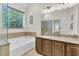 Bathroom features a large soaking tub, granite counters, and a decorative mirror with vanity lighting at 3257 Heathland Way, Mount Pleasant, SC 29466