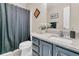 Updated bathroom features a granite countertop, gray vanity, and decorative mirror over sink at 3257 Heathland Way, Mount Pleasant, SC 29466