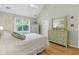 Bright bedroom features a ceiling fan, hardwood floors, and a large window with lots of natural light at 3257 Heathland Way, Mount Pleasant, SC 29466