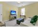 Bright bedroom with a ceiling fan, white sofa, and a TV on console under a window with blinds at 3257 Heathland Way, Mount Pleasant, SC 29466