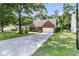 Well-maintained brick home featuring a long driveway, green lawn and mature landscaping at 3257 Heathland Way, Mount Pleasant, SC 29466