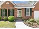 Charming brick home with well-manicured landscaping, black shutters, and a welcoming front door at 3257 Heathland Way, Mount Pleasant, SC 29466