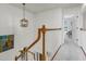 Hallway with wood railing, pendant lighting, and view into a room with a chair at 3257 Heathland Way, Mount Pleasant, SC 29466