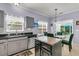 Kitchen with stainless steel appliances, gray cabinets, granite countertops, and a dining area at 3257 Heathland Way, Mount Pleasant, SC 29466