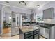 Open-concept kitchen featuring stainless steel appliances, granite counters, and gray cabinets at 3257 Heathland Way, Mount Pleasant, SC 29466