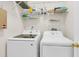 Efficient laundry room equipped with Samsung washer and dryer, shelving, and organized storage for cleaning supplies at 3257 Heathland Way, Mount Pleasant, SC 29466