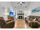 Cozy living room featuring hardwood floors, fireplace, comfortable leather seating, and abundant natural light at 3257 Heathland Way, Mount Pleasant, SC 29466