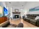 Inviting living room featuring hardwood floors, fireplace, comfortable leather seating, and abundant natural light at 3257 Heathland Way, Mount Pleasant, SC 29466