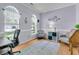 Inviting office space featuring hardwood floors, soothing gray walls, stylish decor, and abundant natural light from arched windows at 3257 Heathland Way, Mount Pleasant, SC 29466