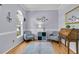 Charming office featuring hardwood floors, soothing gray walls, stylish decor, and natural light from arched windows at 3257 Heathland Way, Mount Pleasant, SC 29466