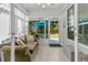 Bright sunroom with tile flooring, lots of natural light, and a comfortable seating area at 3257 Heathland Way, Mount Pleasant, SC 29466
