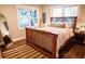 Bright bedroom featuring a wooden bed frame, an area rug and a decorative mirror at 3480 Johan Blvd, Johns Island, SC 29455