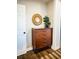 A beautiful wood dresser that is adorned with a plant and a decorative mirror at 3480 Johan Blvd, Johns Island, SC 29455