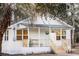 Charming white cottage with a welcoming front porch and lush green surroundings at 3480 Johan Blvd, Johns Island, SC 29455