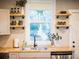 Charming kitchen featuring wood countertops, floating shelves, and a stainless steel sink at 3480 Johan Blvd, Johns Island, SC 29455