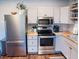 Modern kitchen with stainless steel appliances, including a refrigerator, oven, and microwave at 3480 Johan Blvd, Johns Island, SC 29455