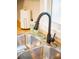 Close-up of a stainless steel sink with a sleek, modern black faucet at 3480 Johan Blvd, Johns Island, SC 29455