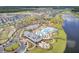 Community aerial with stunning resort pool, community gardens, lush landscaping, and numerous Gathering homes near a lake at 357 Parish Farms Dr, Summerville, SC 29486