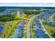 Aerial view of a new construction community with tree-lined streets near a pond at 357 Parish Farms Dr, Summerville, SC 29486