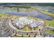 Aerial view of a resort-style community with a large pool, clubhouse, and a lake at 357 Parish Farms Dr, Summerville, SC 29486