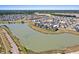 Aerial view of a vibrant community with a central lake surrounded by walking trails and homes at 357 Parish Farms Dr, Summerville, SC 29486