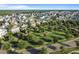 Wide aerial view showcasing colorful homes, lush trees, green space, and well-maintained streets at 357 Parish Farms Dr, Summerville, SC 29486
