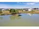 Aerial view of community pond with a wooden gazebo and walking trails surrounded by new homes at 357 Parish Farms Dr, Summerville, SC 29486