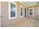 Well maintained covered balcony with wood flooring and view of neighborhood at 357 Parish Farms Dr, Summerville, SC 29486