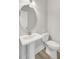 A bathroom featuring a pedestal sink, oval mirror with lighting, and a toilet at 357 Parish Farms Dr, Summerville, SC 29486