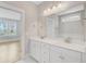 A bathroom with double sinks, large mirror and view of a home across the street at 357 Parish Farms Dr, Summerville, SC 29486