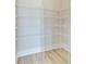 An empty walk-in closet with white wire shelving and light wood flooring at 357 Parish Farms Dr, Summerville, SC 29486