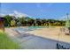Community pool with lounge chairs and umbrellas surrounded by lush greenery at 357 Parish Farms Dr, Summerville, SC 29486