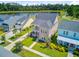 Two-story home boasts double porches, manicured lawn, and vibrant landscaping near a serene lake at 357 Parish Farms Dr, Summerville, SC 29486