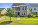 Inviting two-story home with a welcoming porch, green lawn, and sidewalk at 357 Parish Farms Dr, Summerville, SC 29486