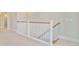 Upstairs hallway featuring a carpeted floor, wooden railings, and an open doorway at 357 Parish Farms Dr, Summerville, SC 29486