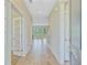 Bright hallway with light wood floors leading to the living space with stairs and windows at 357 Parish Farms Dr, Summerville, SC 29486