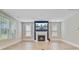 Bright living room features a fireplace, mantle with television, and large windows providing natural light at 357 Parish Farms Dr, Summerville, SC 29486