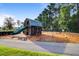 Community playground featuring a barn-themed play structure with a slide and swing sets for outdoor fun at 357 Parish Farms Dr, Summerville, SC 29486