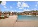 Large community pool with a zero entry, palm trees, lounge chairs, and clubhouse in the background at 357 Parish Farms Dr, Summerville, SC 29486