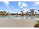 Large community pool with a water slide, palm trees, lounge chairs, and tables with umbrellas at 357 Parish Farms Dr, Summerville, SC 29486