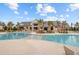 Community pool with zero entry, palm trees, lounge chairs, and tables with umbrellas at 357 Parish Farms Dr, Summerville, SC 29486